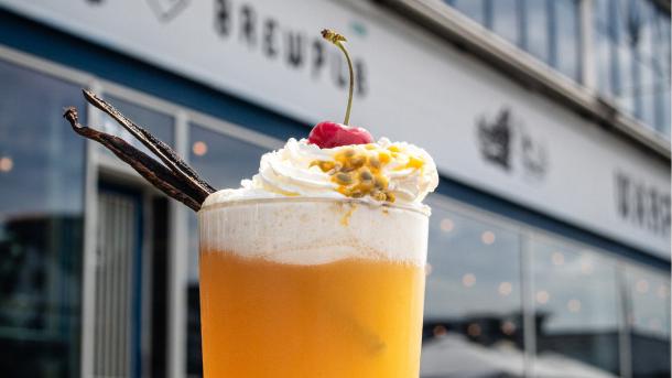 A passion fruit cocktail in front of Warpigs restaurant