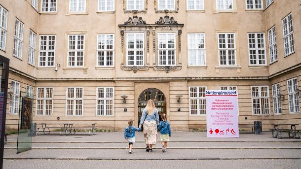 A mother and her two kids in front of the Danish National Museum