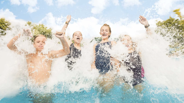 Kids playing in water in a pool