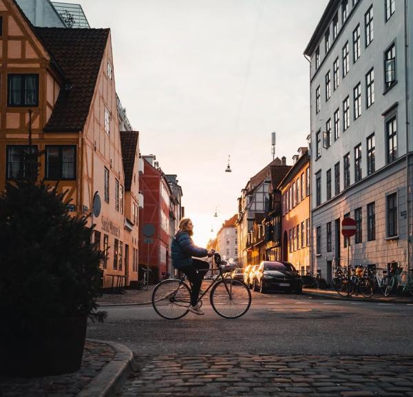 Girl biking in the neighbourhood of Christianshavn in Copenhagen